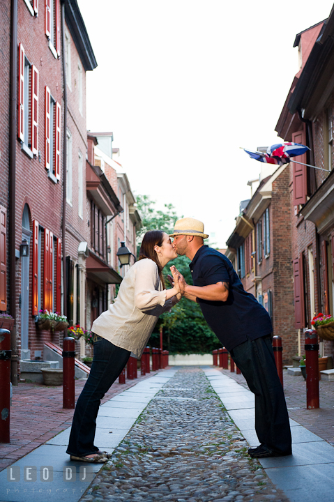 Engaged couple kissing in the Elfreth's Alley. Pre-wedding or engagement photo session at Phillies Ball Park, Love Park, Philadelphia, by wedding photographers of Leo Dj Photography.