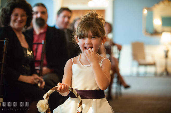 Flower girl walking down the isle with big smile. The Tidewater Inn Wedding, Easton Maryland, ceremony photo coverage by wedding photographers of Leo Dj Photography. http://leodjphoto.com