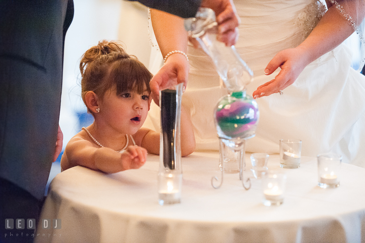 Flower girl in awe during unity sand ceremony. The Tidewater Inn Wedding, Easton Maryland, ceremony photo coverage by wedding photographers of Leo Dj Photography. http://leodjphoto.com