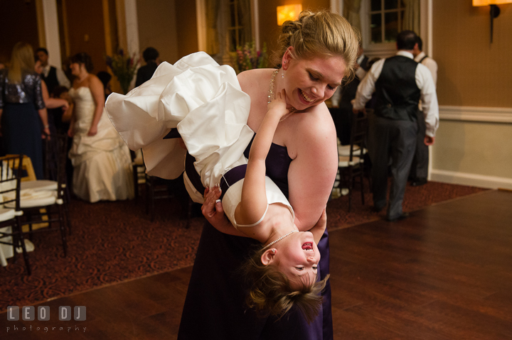 Bridesmaid flipped flower girl upside down and laughing. The Tidewater Inn Wedding, Easton Maryland, reception photo coverage by wedding photographers of Leo Dj Photography. http://leodjphoto.com