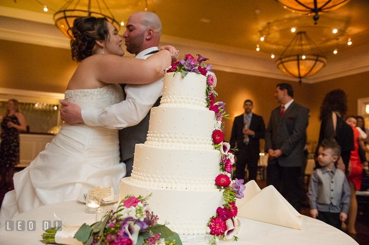 Bride and Groom hugging after the cake cutting. The Tidewater Inn Wedding, Easton Maryland, reception photo coverage by wedding photographers of Leo Dj Photography. http://leodjphoto.com