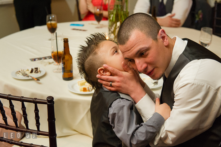 Ring bearer boy whispering to his Daddy. The Tidewater Inn Wedding, Easton Maryland, reception photo coverage by wedding photographers of Leo Dj Photography. http://leodjphoto.com