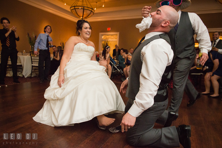 Groom grabbed the garter from Bride with his mouth. The Tidewater Inn Wedding, Easton Maryland, reception photo coverage by wedding photographers of Leo Dj Photography. http://leodjphoto.com