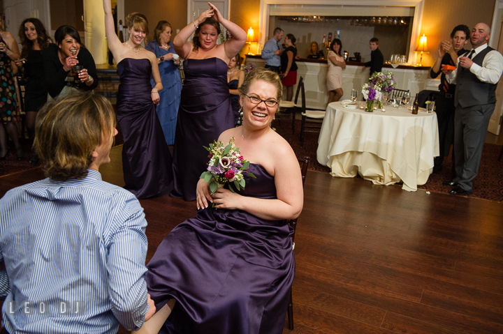 Male guest put garter on Bridesmaid who got the bouquet. The Tidewater Inn Wedding, Easton Maryland, reception photo coverage by wedding photographers of Leo Dj Photography. http://leodjphoto.com