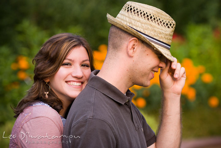 Engaged girl hugging her fiancé from behind. Pre-wedding engagement photo session at Brookside Gardens, Wheaton, Silver Spring, Maryland, by wedding photographer Leo Dj Photography.