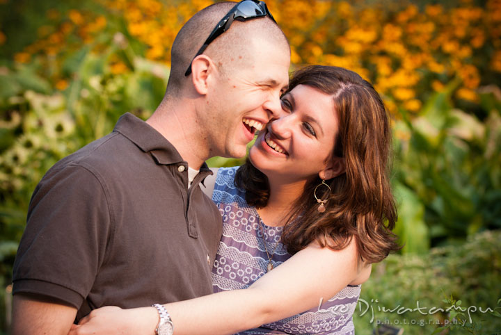 Engaged couple laughing and having fun. Pre-wedding engagement photo session at Brookside Gardens, Wheaton, Silver Spring, Maryland, by wedding photographer Leo Dj Photography.