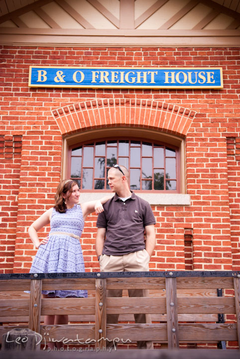 Engaged couple posing by an old B&O Train Freight House. Pre-wedding engagement photo session at Old Town Gaithersburg, Maryland, by wedding photographer Leo Dj Photography.