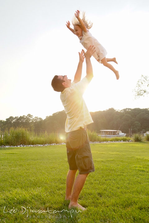 Father playing with her daughter, throwing her up in the air. Kent Island and Annapolis, Eastern Shore, Maryland Candid Family Maternity Session Photographer