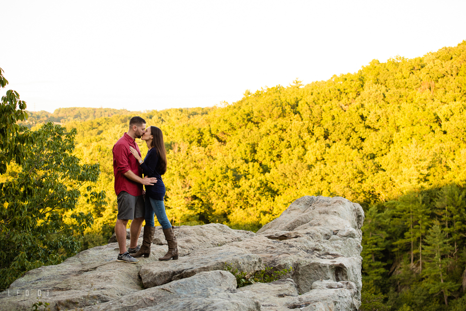 Rocks State Park Bel Air Maryland engaged man and fiancee kissing on King and Queen Seat photo by Leo Dj Photography.