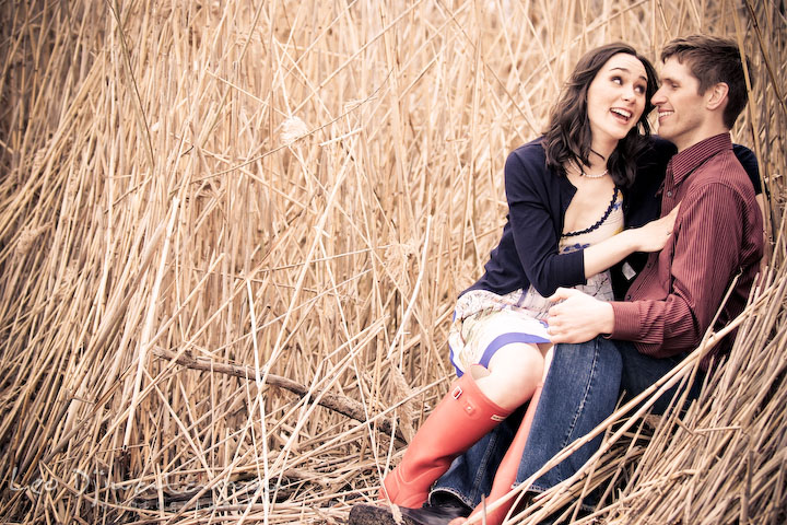 couple sitting by straws, laughing. Engagement session model photography - Annapolis photographer