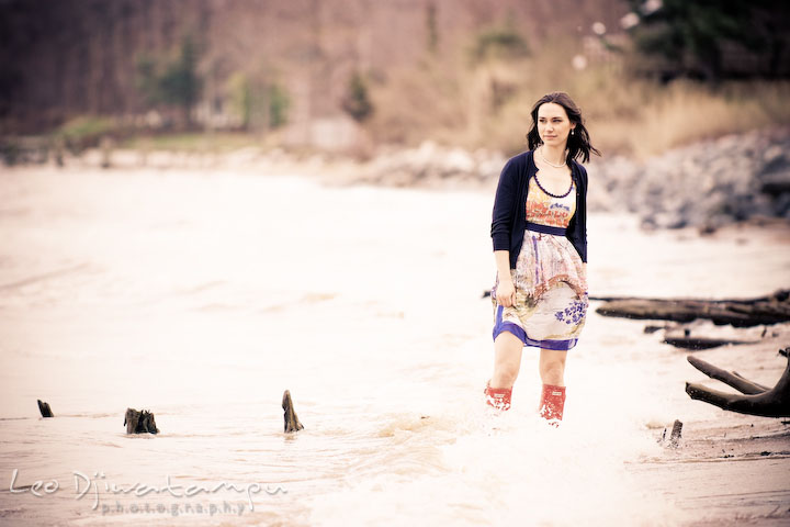 model on the beach, red boots strucked by the waves. Engagement session model photography - Annapolis photographer