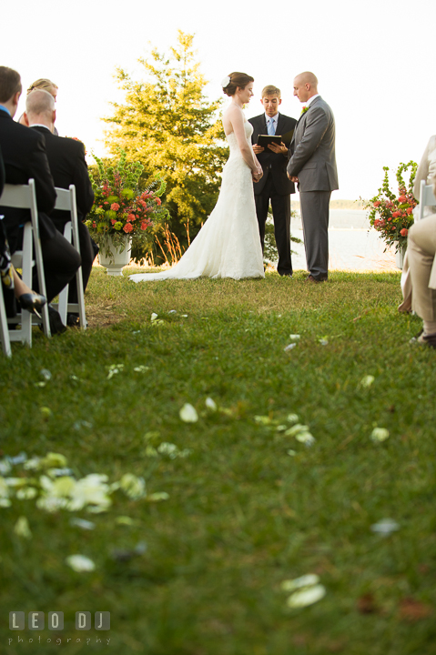 View of Bride and Groom from the aisle with the flower petals during the ceremony. Hyatt Regency Chesapeake Bay wedding at Cambridge Maryland, by wedding photographers of Leo Dj Photography. http://leodjphoto.com