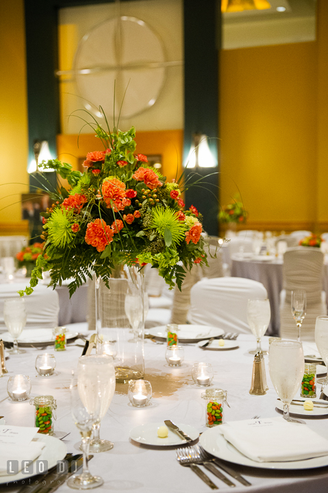 Table centerpiece decorations with orange and green flowers. Hyatt Regency Chesapeake Bay wedding at Cambridge Maryland, by wedding photographers of Leo Dj Photography. http://leodjphoto.com