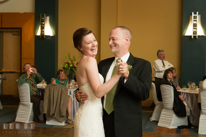 Bride laughing while performing parent dance with her Father. Hyatt Regency Chesapeake Bay wedding at Cambridge Maryland, by wedding photographers of Leo Dj Photography. http://leodjphoto.com