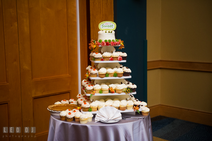 Wedding cake, tiers of cup cakes, and pumpkin pie from Mabel's bakery with flower decorations. Hyatt Regency Chesapeake Bay wedding at Cambridge Maryland, by wedding photographers of Leo Dj Photography. http://leodjphoto.com