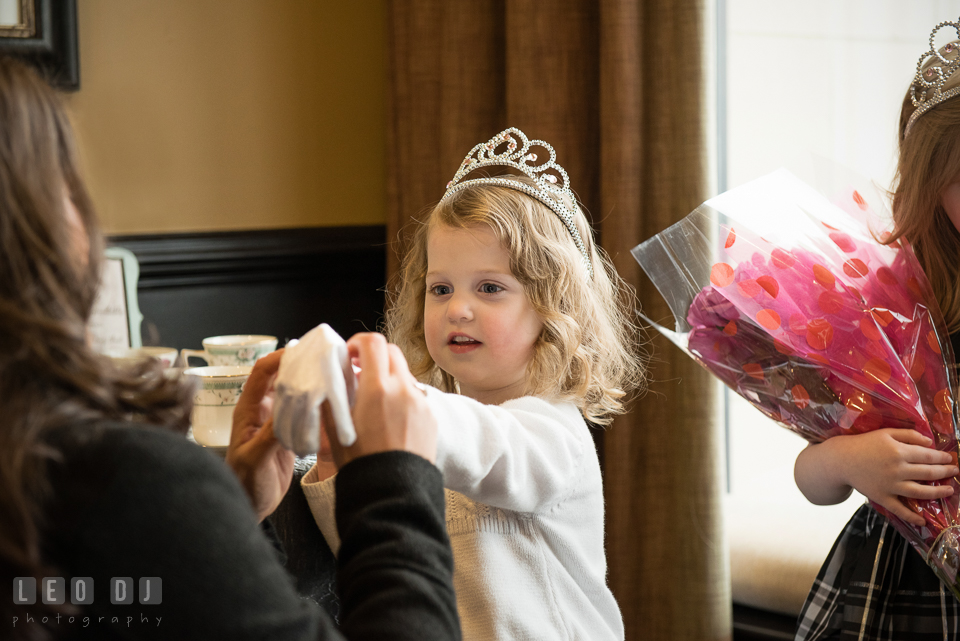 Guest helping putting on white gloves for a little girl with tiara. Historic Events Annapolis bridal shower decor and event coverage at Annapolis Maryland, by wedding photographers of Leo Dj Photography. http://leodjphoto.com