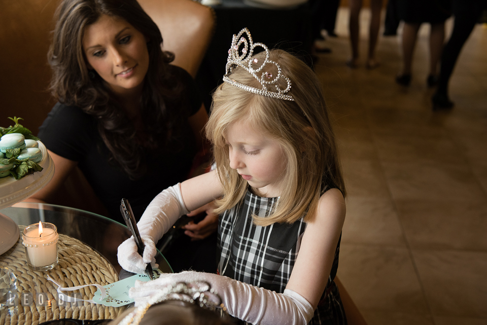 Little girl wearing tiara writing well wishes for the Bride-to-be. Historic Events Annapolis bridal shower decor and event coverage at Annapolis Maryland, by wedding photographers of Leo Dj Photography. http://leodjphoto.com