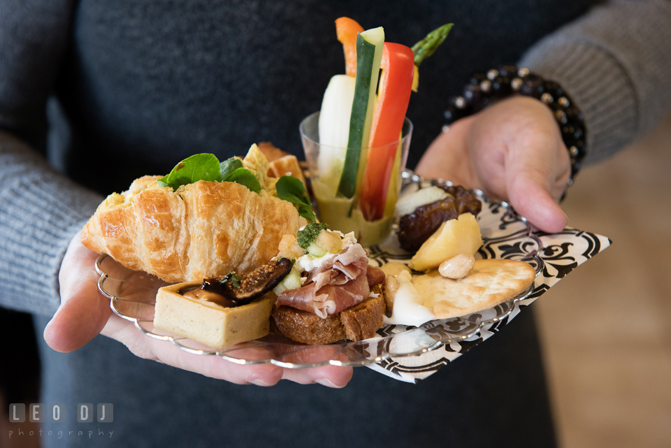 Guest holding a plate of various hors d'oeuvres from Strawberry Banke Events catering. Historic Events Annapolis bridal shower decor and event coverage at Annapolis Maryland, by wedding photographers of Leo Dj Photography. http://leodjphoto.com