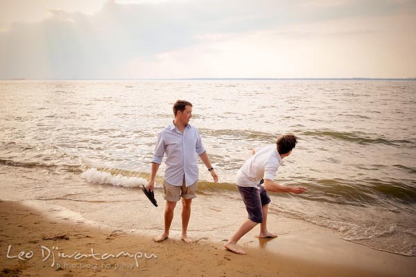 Guy throwing rock at wave. Kent Island Annapolis Candid Family Portrait Photo Session Photography Eastern Shore Maryland MD DC