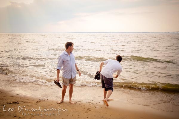 Throwing rock to water, brother looking. Kent Island Annapolis Candid Family Portrait Photo Session Photography Eastern Shore Maryland MD DC