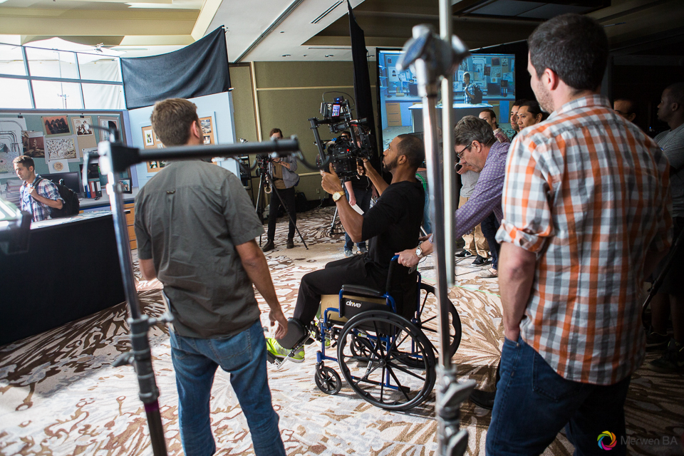 Shane pushing a camera operator using a wheel chair in place of a dolly on a track. Review of MZed Illumination Experience, film making and cinematography Workshop with Hollywood Cinematographer Shane Hurlbut by wedding photographer Leo Dj Photography. http://leodjphoto.com