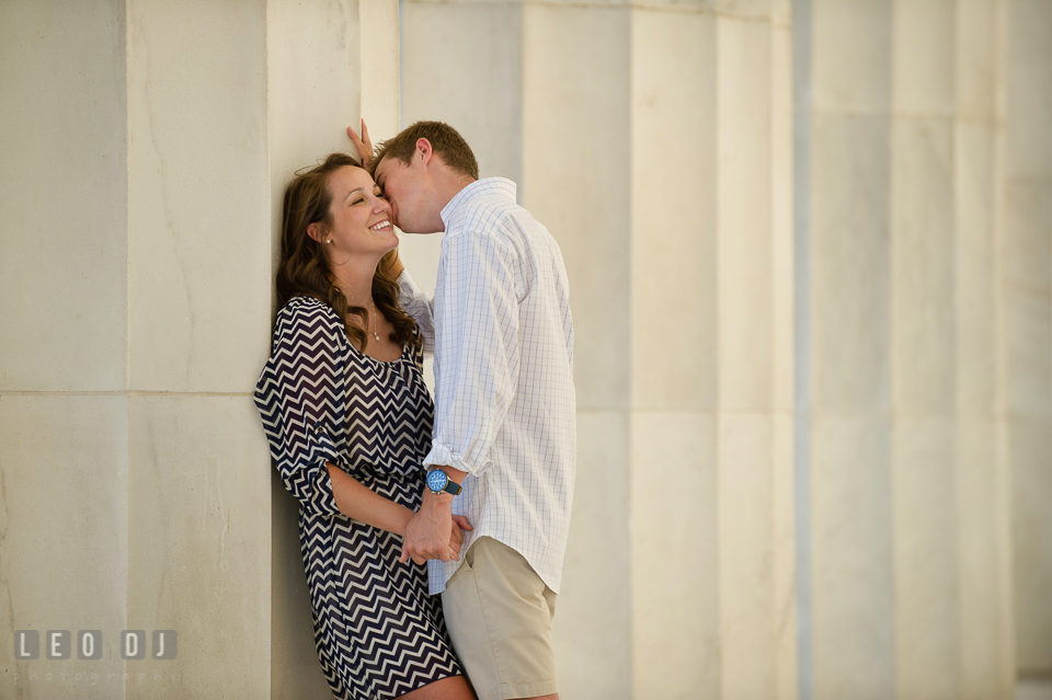 Engaged girl kissed on the cheek by her fiancé. Washington DC pre-wedding engagement photo session at Lincoln Memorial, by wedding photographers of Leo Dj Photography. http://leodjphoto.com