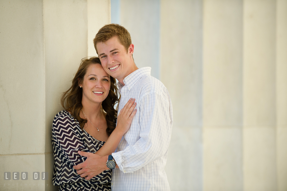 Engaged couple posing by the large marble columns. Washington DC pre-wedding engagement photo session at Lincoln Memorial, by wedding photographers of Leo Dj Photography. http://leodjphoto.com