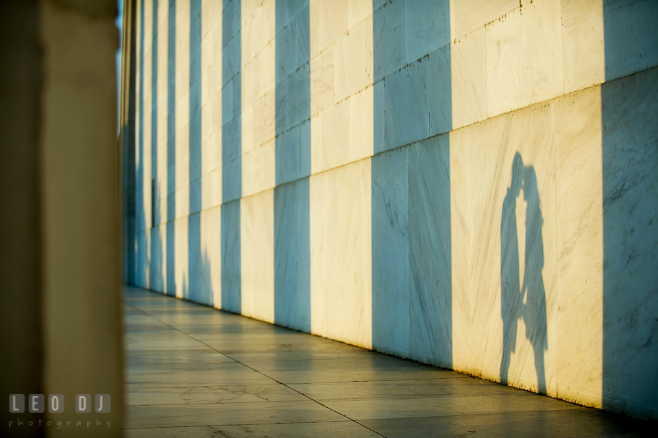 Shadow of engaged couple holding hands and almost kissing. Washington DC pre-wedding engagement photo session at Lincoln Memorial, by wedding photographers of Leo Dj Photography. http://leodjphoto.com