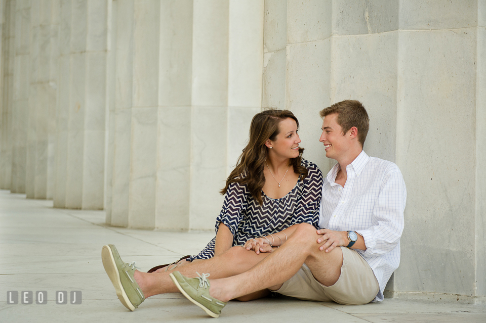 Engaged couple sitting and looking at each other. Washington DC pre-wedding engagement photo session at Lincoln Memorial, by wedding photographers of Leo Dj Photography. http://leodjphoto.com