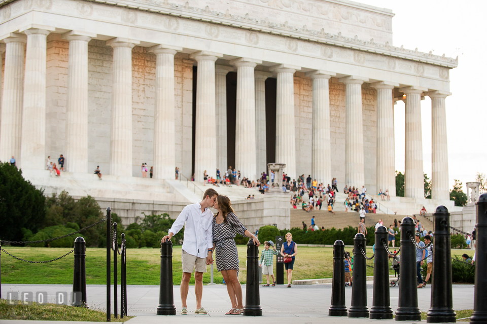 Engaged guy and girl kissing in front of the Abraham Lincoln Memorial. Washington DC pre-wedding engagement photo session at Lincoln Memorial, by wedding photographers of Leo Dj Photography. http://leodjphoto.com