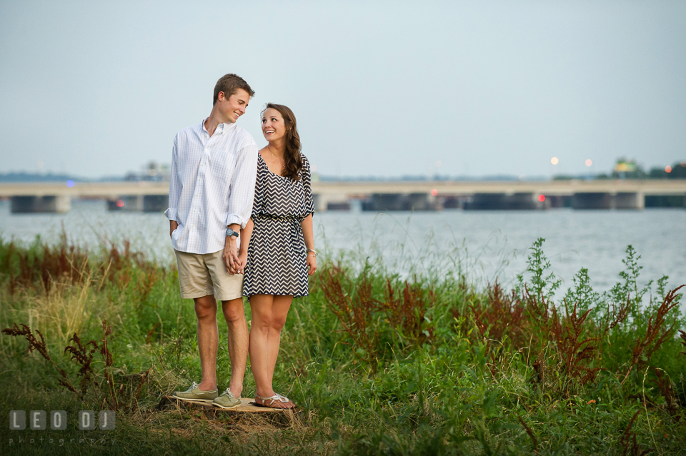 Engaged guy holding hands with his fiancee by the Tidal Basin. Washington DC pre-wedding engagement photo session at Lincoln Memorial, by wedding photographers of Leo Dj Photography. http://leodjphoto.com