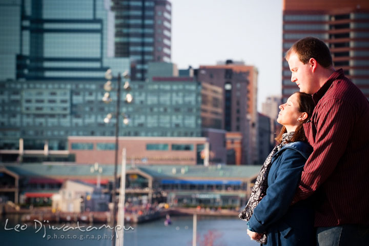 Engaged girl leaning to her fiancé and both enjoying each other's presence. Pre-wedding Engagement Photo Session Federal Hill Baltimore and Mother's Grille restaurant bar by wedding photographer Leo Dj Photography