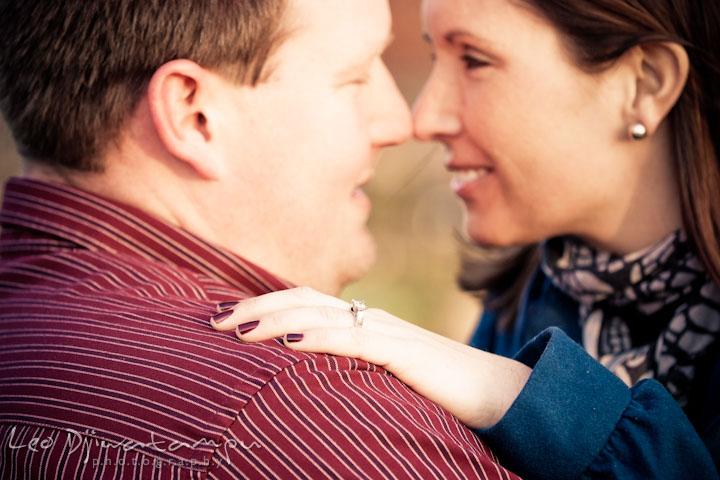 Engaged girl rubbing nose with her fiancé, smiling and showing her diamond engagement ring. Pre-wedding Engagement Photo Session Federal Hill Baltimore and Mother's Grille restaurant bar by wedding photographer Leo Dj Photography