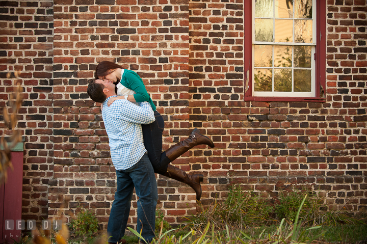 Engaged guy lift up his fiancé and kissed her. Annapolis Eastern Shore Maryland pre-wedding engagement photo session at downtown, by wedding photographers of Leo Dj Photography. http://leodjphoto.com