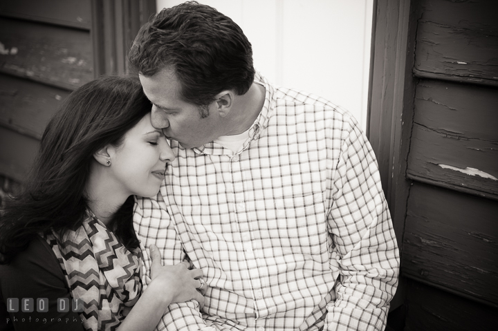 Engaged guy cuddling with his fiancée and kissed her. Annapolis Eastern Shore Maryland pre-wedding engagement photo session at downtown, by wedding photographers of Leo Dj Photography. http://leodjphoto.com