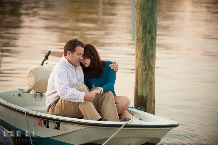 Engaged girl cuddling with her fiancé on a boat on a pier at Eastport. Annapolis Eastern Shore Maryland pre-wedding engagement photo session at downtown, by wedding photographers of Leo Dj Photography. http://leodjphoto.com