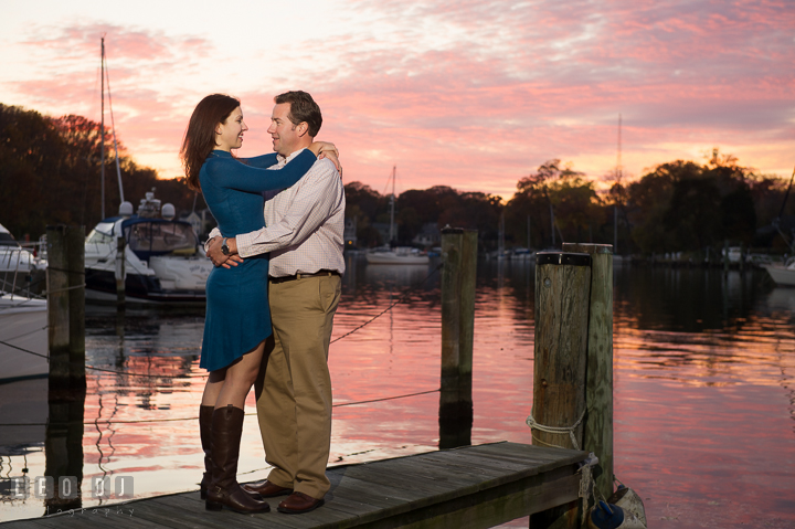 Engaged couple embracing on a boat dock at Eastport with gorgeous sunset sky. Annapolis Eastern Shore Maryland pre-wedding engagement photo session at downtown, by wedding photographers of Leo Dj Photography. http://leodjphoto.com