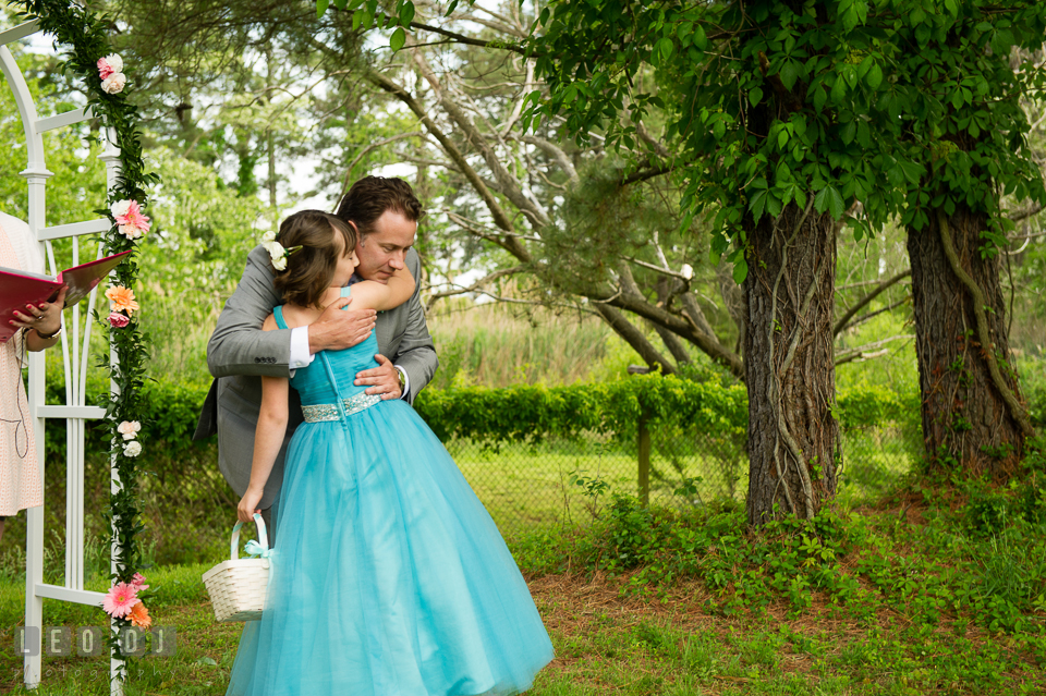 One last hug from the flower girl to the Groom before ceremony begins. Chesapeake Bay Environmental Center, Eastern Shore Maryland, wedding reception and ceremony photo, by wedding photographers of Leo Dj Photography. http://leodjphoto.com