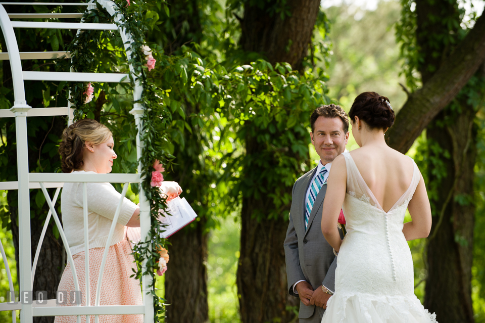 Groom smiles lovingly at his Bride during the wedding ceremony. Chesapeake Bay Environmental Center, Eastern Shore Maryland, wedding reception and ceremony photo, by wedding photographers of Leo Dj Photography. http://leodjphoto.com