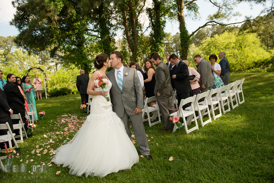 Tender kisses between the Bride and Groom on the aisle after the wedding ceremony. Chesapeake Bay Environmental Center, Eastern Shore Maryland, wedding reception and ceremony photo, by wedding photographers of Leo Dj Photography. http://leodjphoto.com