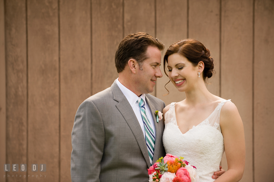 Bride and Groom hugging and smiling together. Chesapeake Bay Environmental Center, Eastern Shore Maryland, wedding reception and ceremony photo, by wedding photographers of Leo Dj Photography. http://leodjphoto.com