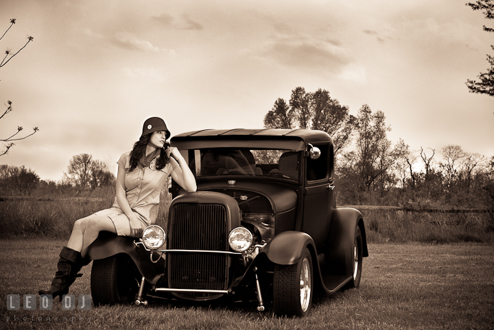 Black and white photo of girl with vintage Hollywood style pose and lighting on an antique Ford model car. Model portrait session with Brittany from Beyond the Veil music Band and her Siberian Husky pet dog at Kent Island, Maryland Eastern Shore by photographer Leo Dj Photography.