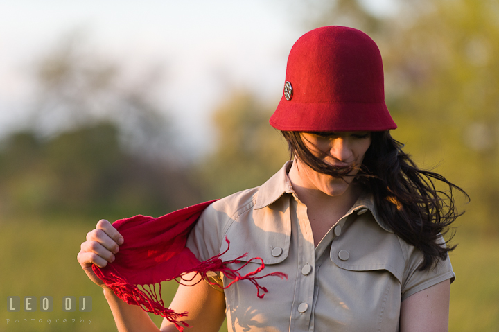 Girl holding her red scarf while hair blown by wind. Model portrait session with Brittany from Beyond the Veil music Band and her Siberian Husky pet dog at Kent Island, Maryland Eastern Shore by photographer Leo Dj Photography.