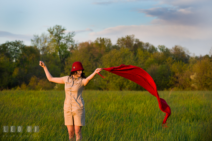 Girl with vintage red hat playing with red scarf blowing in the wind. Model portrait session with Brittany from Beyond the Veil music Band and her Siberian Husky pet dog at Kent Island, Maryland Eastern Shore by photographer Leo Dj Photography.