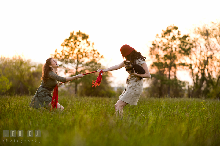 Girl with red hat playing tug o' war with her sister. Model portrait session with Brittany from Beyond the Veil music Band and her Siberian Husky pet dog at Kent Island, Maryland Eastern Shore by photographer Leo Dj Photography.