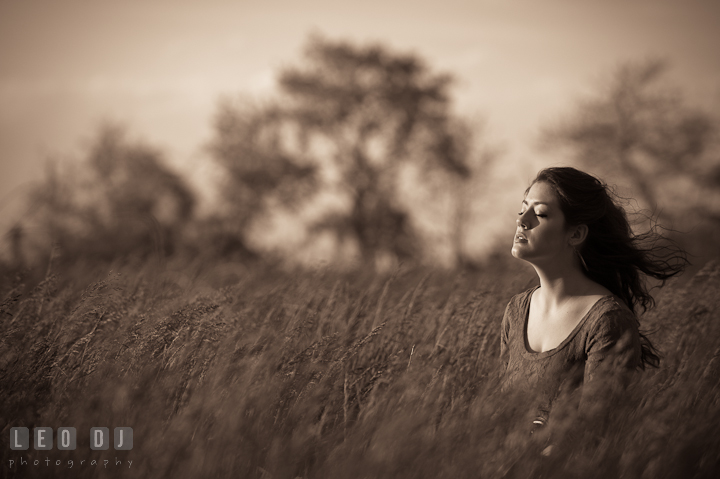 Girl in a grass meadow enjoying the wind on her face. Eastern Shore, Maryland, Kent Island High School senior portrait session by photographer Leo Dj Photography. http://leodjphoto.com