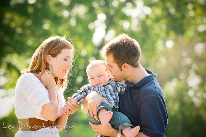 Father and mother holding and playing with their baby boy. Eastern Shore Maryland Kent Island Family Lifestyle Portrait Photo Session by Photographer Leo Dj Photography