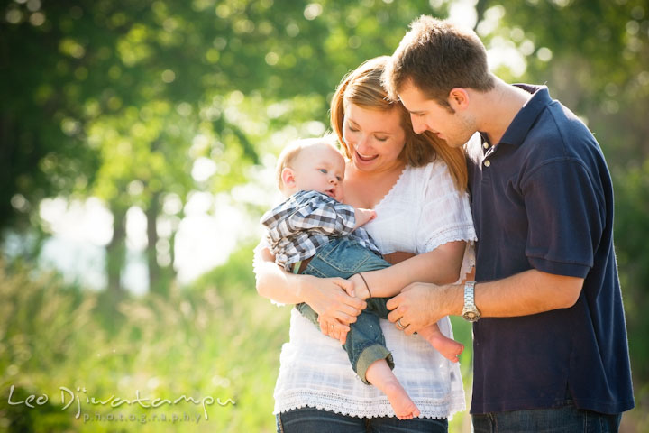 Mother holding his baby boy. Father talking to baby. Eastern Shore Maryland Kent Island Family Lifestyle Portrait Photo Session by Photographer Leo Dj Photography