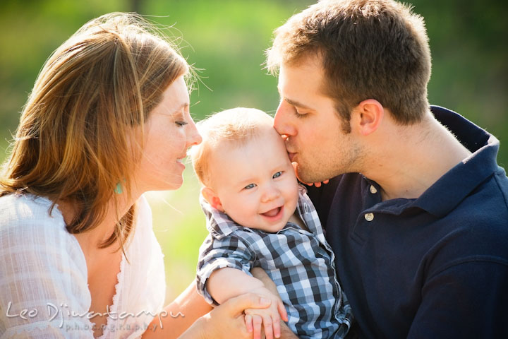 A father and mother kissed their baby boy. Eastern Shore Maryland Kent Island Family Lifestyle Portrait Photo Session by Photographer Leo Dj Photography