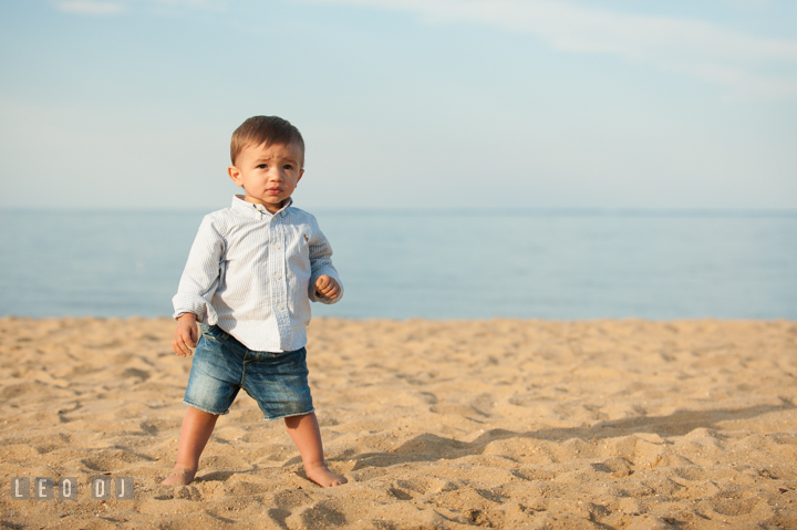 Little toddler boy standing on the beach. Kent Island, Annapolis, Eastern Shore Maryland candid children and family lifestyle portrait photo session by photographers of Leo Dj Photography. http://leodjphoto.com